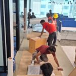 How We Safely Relocated 80 Television Sets from Bangalore to KGF – A Bulk Electronics Shifting Case Study 3 Movers carefully packing electronics for bulk TV relocation from Bangalore to KGF