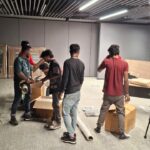 How We Safely Relocated 80 Television Sets from Bangalore to KGF – A Bulk Electronics Shifting Case Study 6 Packing team securing bubble wrap around a TV screen for safe relocation